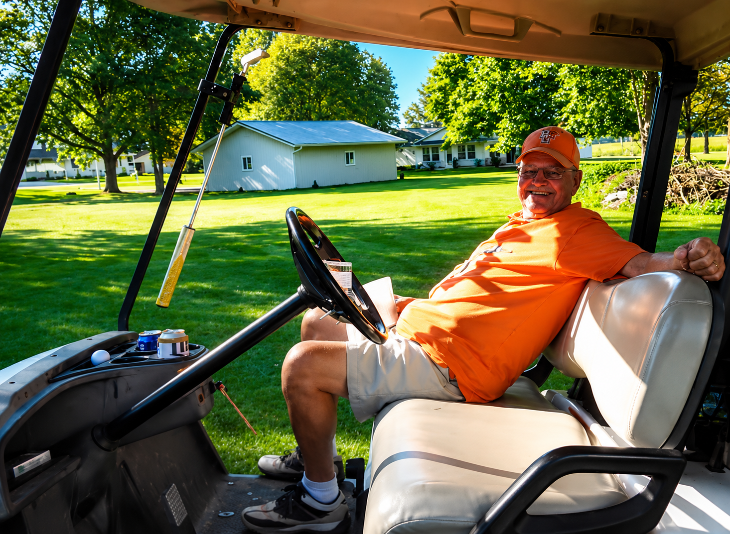 Merle Trumbull smiling from a golf cart on a sunny day on the course